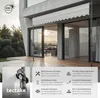 A modern house with a retractable awning extended over a wooden deck. Náhled obrázku produktu