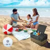 A family is having a picnic on the beach with a portable refrigerator. Náhled obrázku produktu
