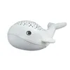 A white whale-shaped night light with star patterns on its back, shown against a white background. Produktbild-Vorschau