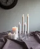 Several LED candles of varying heights are arranged on a draped purple cloth, with a clock visible in the background. Podgląd zdjęcia produktu