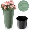 A tall, green planter with a textured surface, filled with pink and white azaleas. A separate black insert pot is shown to the right, along with a close-up of the planter's texture. Voir les images du produit