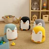 A collection of plush penguin toys in a child's play area. Produktbild-Vorschau