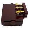 A close-up, angled view of a brown piano pedal extender with three gold pedals on a white background. Náhled obrázku produktu
