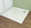 A white rectangular shower tray is shown in a bathroom corner, with wooden flooring and a window with blinds. Produktbild-Vorschau