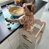 A baby is playing in a kitchen learning tower. Náhled obrázku produktu