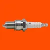 A single spark plug is shown against an orange background. Náhľad obrázku produktu
