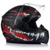 A black motorcycle helmet with a red and white graphic design of a monster's face, displayed on a white background. Produktbild-Vorschau