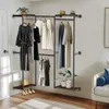 A well-organized walk-in closet with a metal and wood garment rack holding various clothing items and accessories. Produktbild-Vorschau
