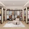 A well-lit, spacious walk-in closet with an open wardrobe system, clothing, and furniture. Produktbild-Vorschau