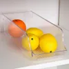 A clear plastic storage container filled with fruit on a shelf. Náhled obrázku produktu