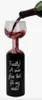A wine bottle is pouring red wine into a unique wine glass that is shaped like a wine bottle. The glass has text written on it. Náhľad obrázku produktu