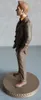 A side profile of a figurine of a man in a suit, standing on a circular base. Produktbild-Vorschau