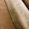 A close-up view of the texture and stitching of a soft blanket. Produktbild-Vorschau