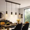 A dining room with a table set for a meal, illuminated by a pendant light fixture. Podgląd zdjęcia produktu