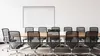 A conference room with a whiteboard and chairs around a table. Produktbild-Vorschau