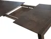 A close-up view of a dark gray extendable table with a white background. Produktbild-Vorschau