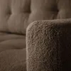 A close-up shot of the textured armrest of a brown sofa. Náhled obrázku produktu