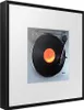 A framed image of a turntable with a vinyl record playing. Náhled obrázku produktu