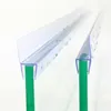 Two clear plastic shower door seals are shown attached to green glass panels, with water droplets on the seals. Podgląd zdjęcia produktu
