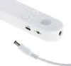 Close-up view of the end of a white LED strip light with a USB port, a switch, and a DC power input. A white power cable with a DC connector is also shown. Náhľad obrázku produktu