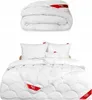 A folded duvet and a made-up bed with pillows and a duvet. Produktbild-Vorschau