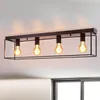 A black, rectangular ceiling light fixture with four exposed Edison-style bulbs is mounted on a white ceiling. Voir les images du produit