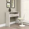 A white desk with two drawers and a shelf, next to a white chair in a room with a window. Náhled obrázku produktu