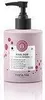 A pink bottle of hair mask with a black pump dispenser, set against a white background. Produktbild-Vorschau