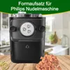 A close-up view of a black pasta maker attachment with heart-shaped pasta in the foreground, set against a blurred kitchen background and a green overlay with text. Produktbild-Vorschau