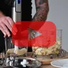 A person is using a hand blender to process food in a container. Produktbild-Vorschau