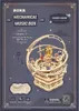 The image shows the packaging of a ROKR Mechanical Music Box, specifically the 'Starry Night' model. The packaging features a dark blue background with decorative elements and text describing the product. A 3D wooden model of the music box is prominently d Produktbild-Vorschau