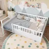 A child's bedroom with a white wooden bed, decorated with a mountain mural and a colorful polka dot rug. Anteprima dell’immagine prodotto