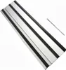 A silver guide rail with black rubber strips and a small metal piece with holes. Produktbild-Vorschau