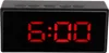 A black digital alarm clock with a red LED display showing "6:00". The top of the clock has several buttons labeled. Voir les images du produit