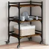 A three-tiered kitchen cart with a rustic wood finish and black metal frame, placed in a corner against a wall. Náhľad obrázku produktu