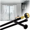 A double curtain rod with a decorative ball finial is shown in the foreground, with a blurred background of a room with sheer curtains on a window. Produktbild-Vorschau