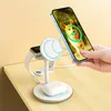 A hand is holding a smartphone over a white charging station that is charging an Apple Watch and AirPods. Produktbild-Vorschau