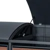 A close-up view of the lid and gas struts of a dark gray outdoor storage box with a curved lid, revealing the interior structure and wooden panels below. Produktbild-Vorschau
