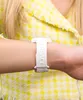 A close-up shot of a person's wrist wearing a white Versace watch. Náhled obrázku produktu