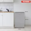 A silver Telefunken refrigerator with dimensions indicated by measurement lines, placed next to a white kitchen cabinet with a sink and faucet. Produktbild-Vorschau