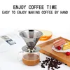 A coffee filter and cup set with cake and coffee beans in the background. Náhľad obrázku produktu