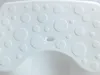 A close-up view of a white bath stool with a pattern of raised circles. Podgląd zdjęcia produktu