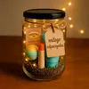 A gift jar filled with bath and body products, decorated with fairy lights and a gift tag. Produktbild-Vorschau