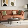 A living room scene with a brown sofa, coffee table, and artwork. Podgląd zdjęcia produktu