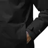 A close-up of a person's arm in a black jacket, showing a pocket and the sleeve cuff with a logo. Produktbild-Vorschau