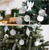 Two images of Christmas tree ornaments, one showing a cake in the background. Voir les images du produit