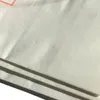 A close-up view of a white paper product, possibly a vacuum cleaner bag, with some creasing and shadows. Produktbild-Vorschau