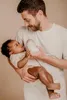 A father is feeding his baby from a bottle. Produktbild-Vorschau