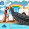 A child dressed as a superhero holds up a gray fabric canopy in front of a washing machine and a rainbow. Produktbild-Vorschau
