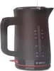 A black electric kettle with red accents is shown against a white background. Water is being poured into the top. Podgląd zdjęcia produktu